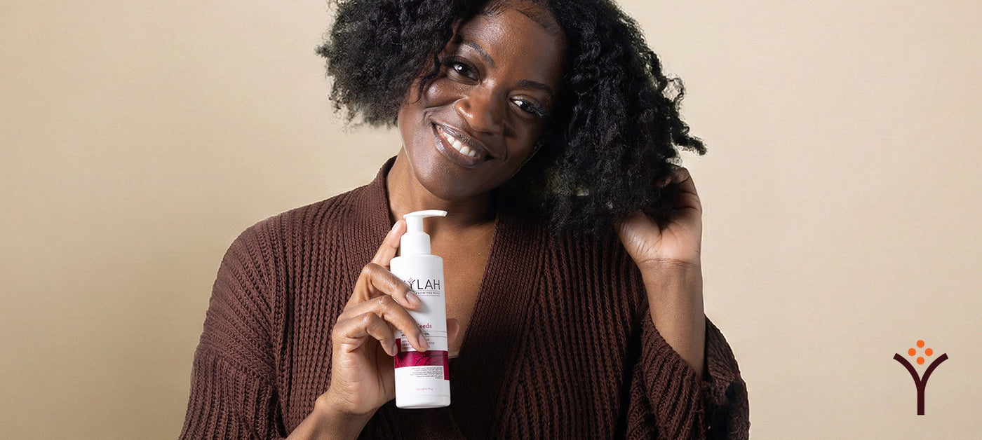 Model holding Nylah's Naturals Super Seed Oil