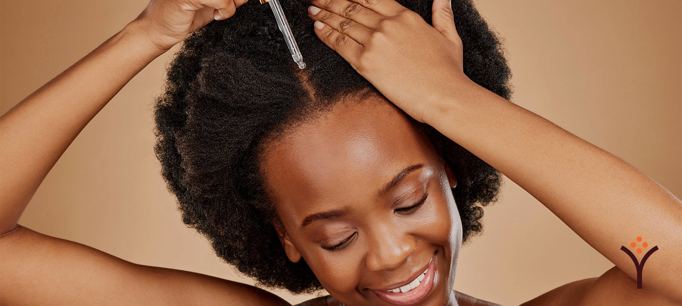 Woman applying hair growth serum